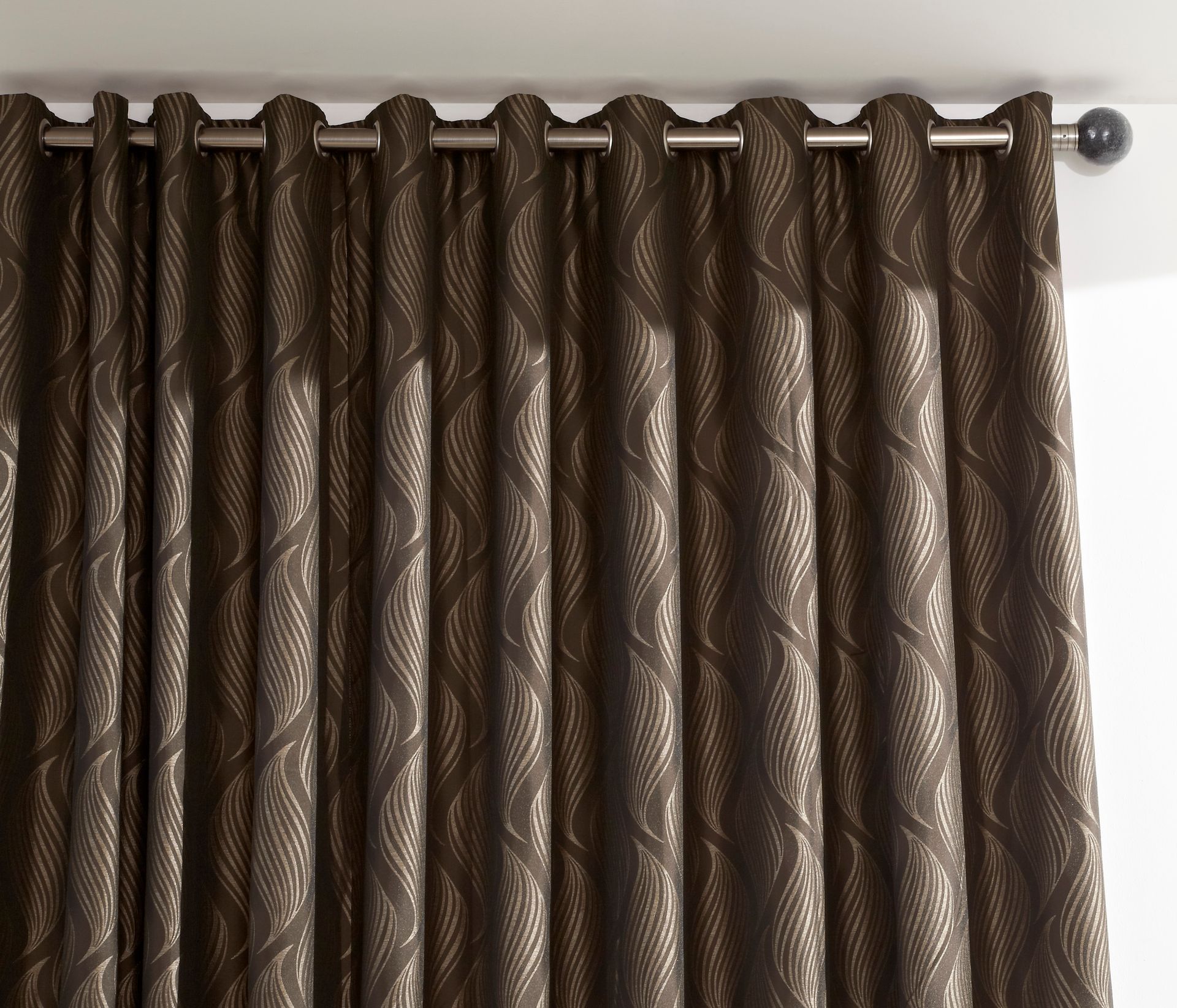 A close up of a pair of brown curtains
