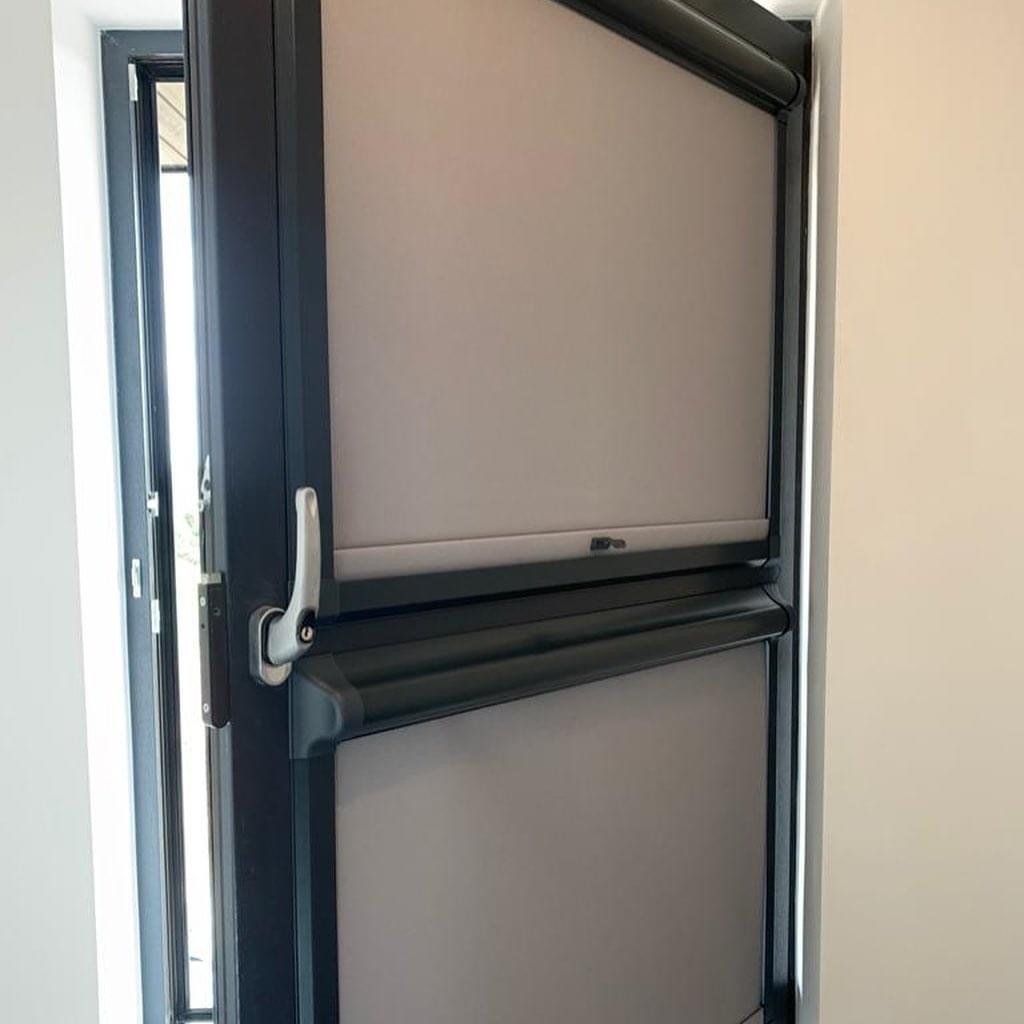 A close up of a door with blinds on it.