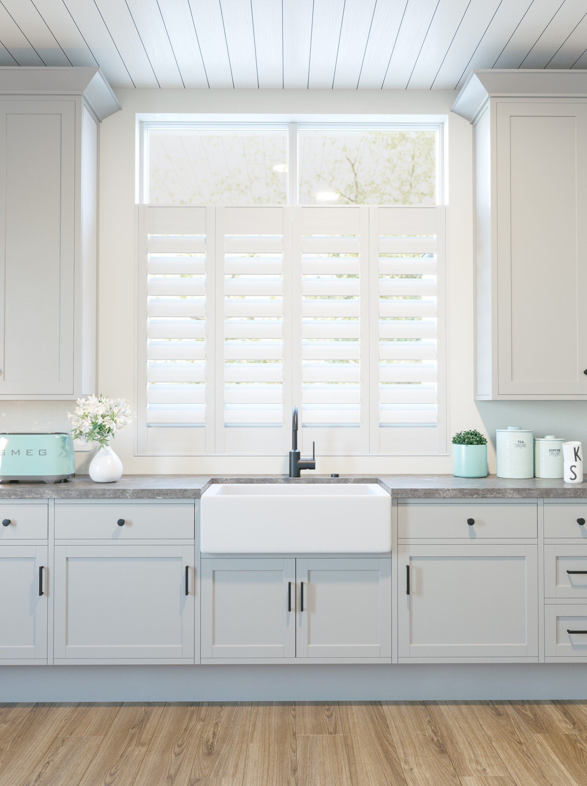 A kitchen with white cabinets , a sink , a window and shutters.