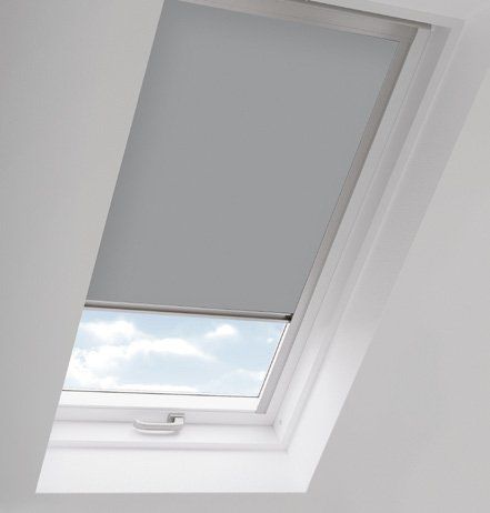 A white skylight with a gray blind on it.