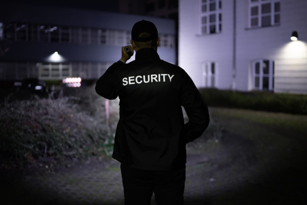 A Security Guard With A Security Patch On His Back — Coastal Protection Services Pty Ltd In Berkeley Vale, NSW
