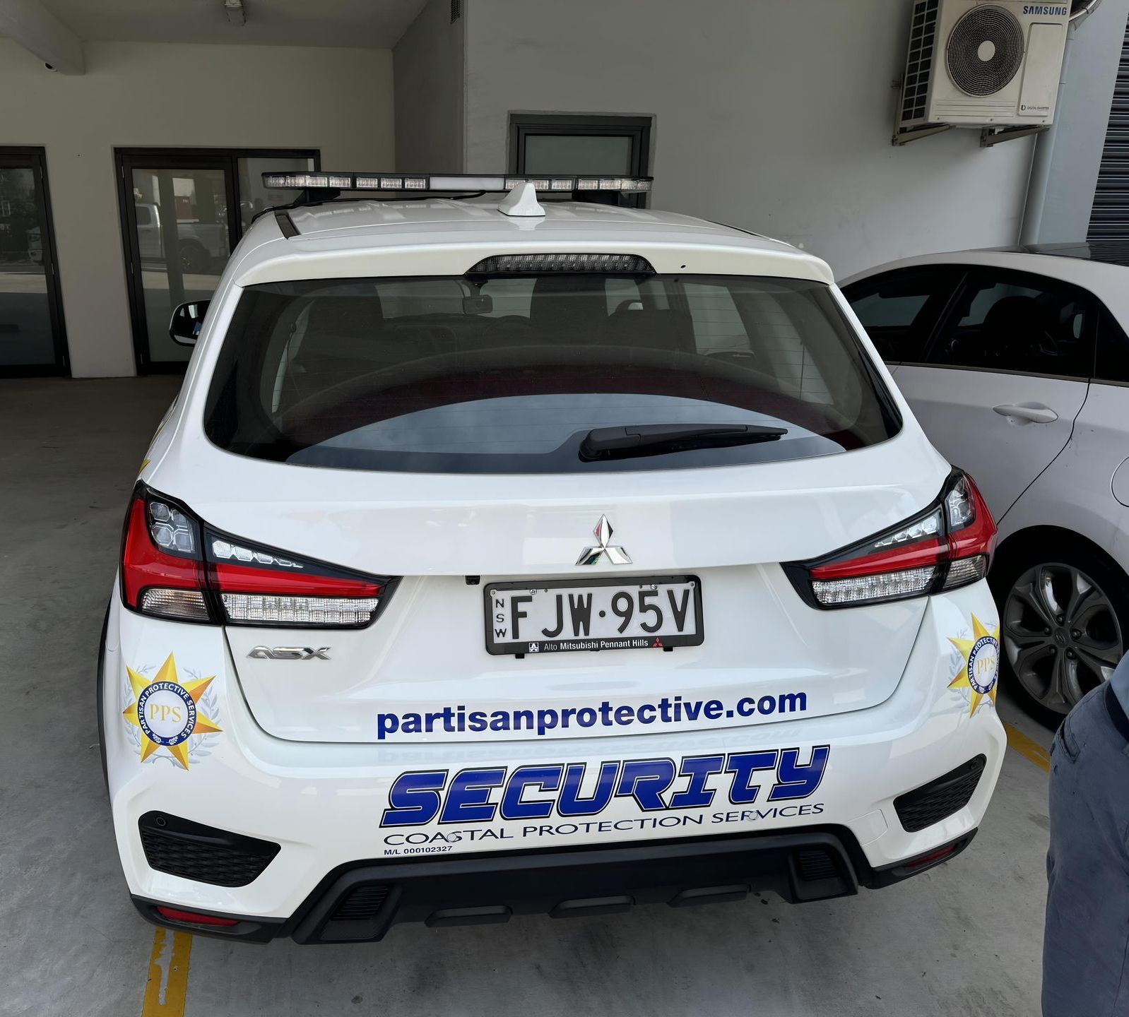 A White Car With The Word Security On The Back — Coastal Protection Services Pty Ltd In Central Coast, NSW