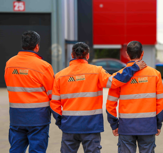 A Security Guard Is Sitting In Front Of Two Computer Monitors — Coastal Protection Services Pty Ltd In Central Coast, NSW