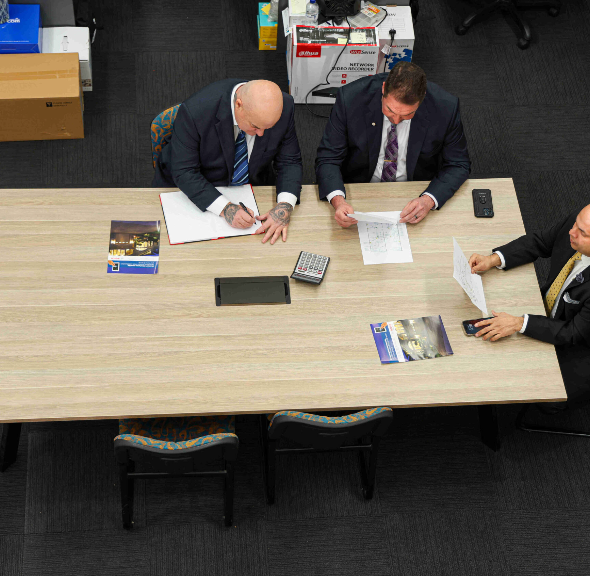 A Group Of Security Guards are Sitting — Coastal Protection Services Pty Ltd In Woy Woy, NSW
