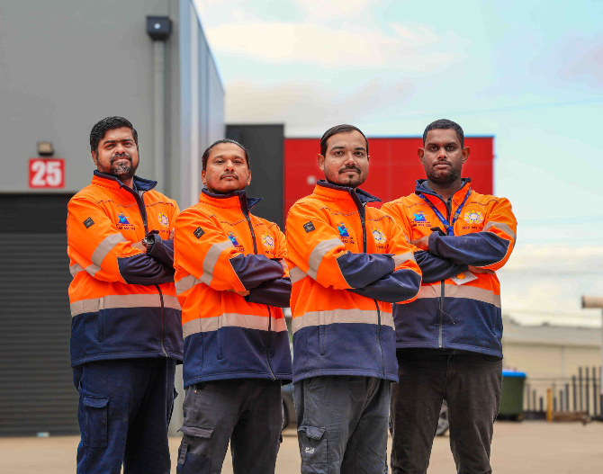 A Security Guard Is Standing In Front Of A Crowd Of People — Coastal Protection Services Pty Ltd In Wyong, NSW