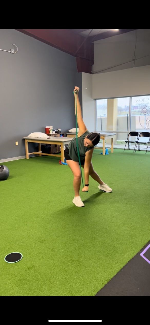 a woman is doing a tpi golf training in a gym .