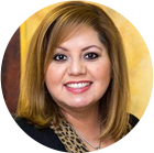 A woman in a black shirt and leopard print scarf is smiling in a circle.