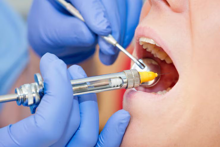 close up dentist examining patient teeth
