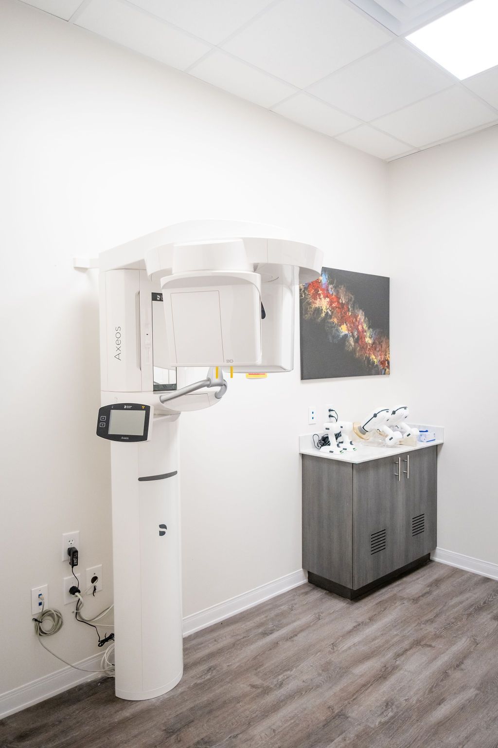 A woman is getting an x-ray of her teeth in a dental office.