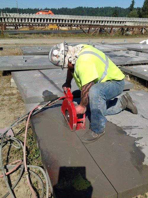 Man cutting concrete slab with a saw - Concrete slab sawing in Milton, WA