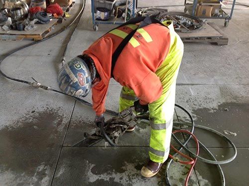 Man cutting concrete foundation with a saw - Concrete Sawing in Milton, WA