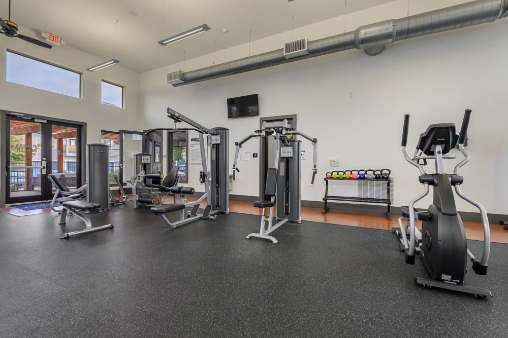 A large gym filled with lots of exercise equipment at Marquis SoCo in South Austin, TX.