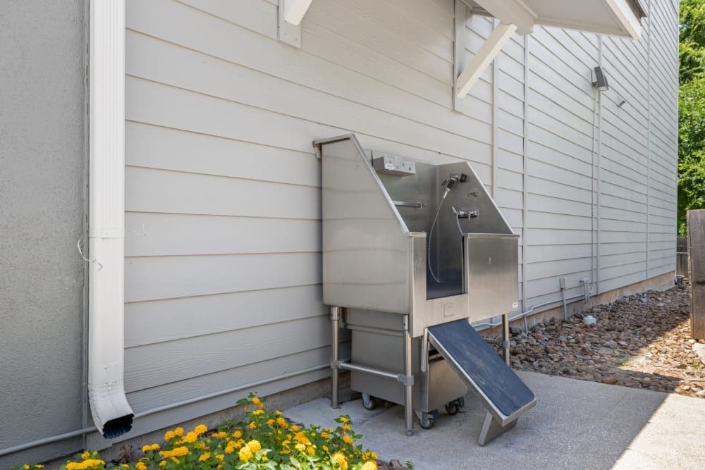 A stainless steel dog wash sink is sitting outside at Marquis SoCo in South Austin, TX.