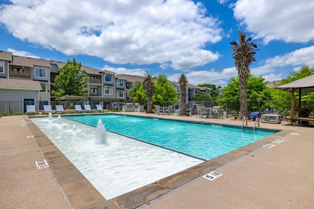 Apartment swimming pool with a fountain at Marquis SoCo in South Austin, TX.