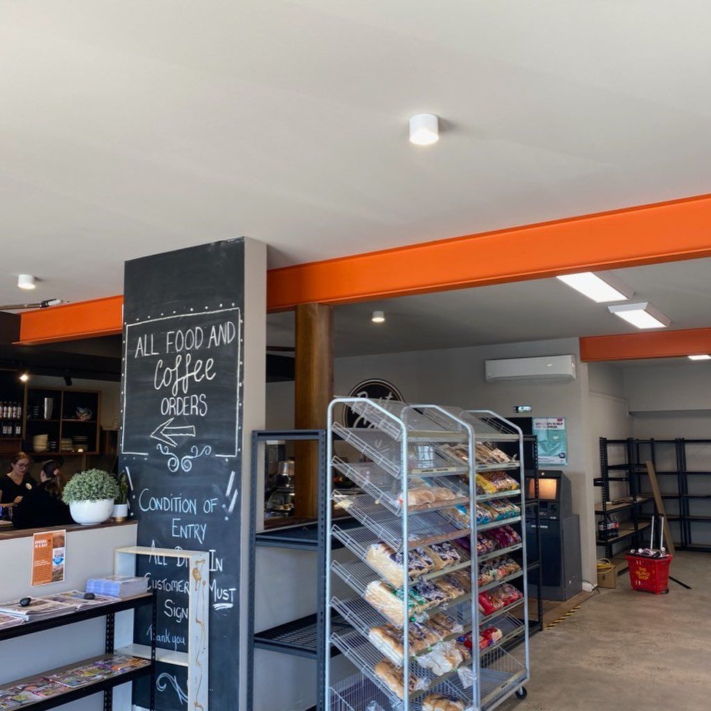 A bakery with a chalkboard that says all food and coffee