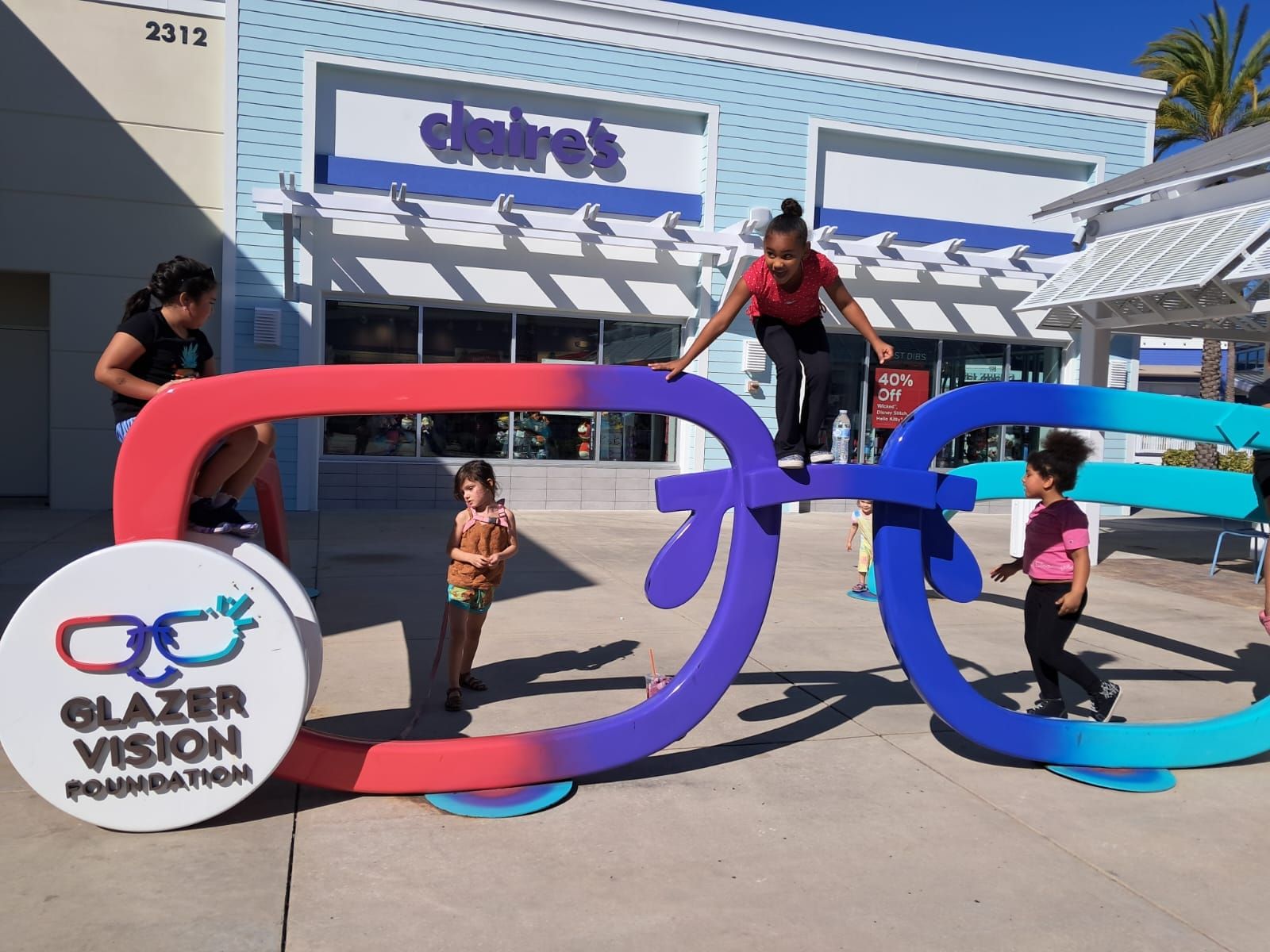 A group of people standing around a sign that says blazer vision