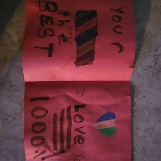 A book is open to a page that says `` you 're the best '' and `` i love you ''.