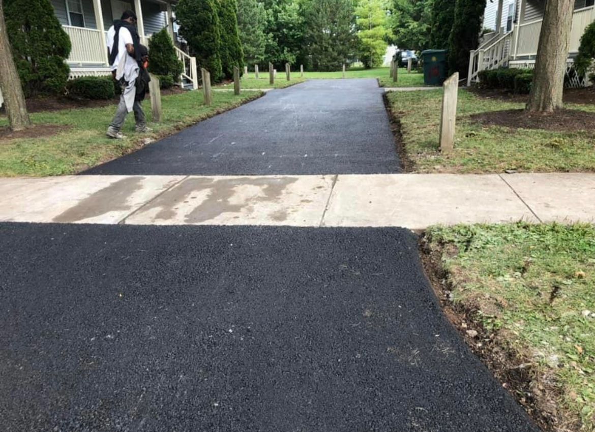 Asphalt driveway maintenance and sealcoating services by Universal Paving & Concrete in Rochester, NY, designed to protect and extend the life of your driveway.