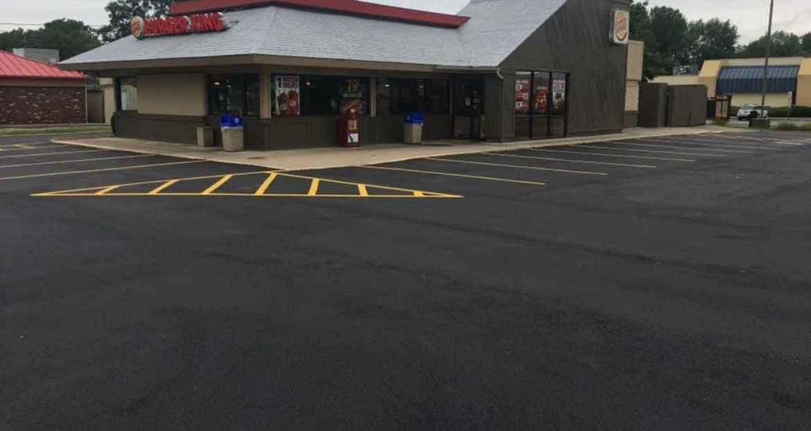 Universal Paving & Concrete paving a commercial lot in Rochester, NY, ensuring an even, long-lasting surface for businesses, warehouses, and offices.