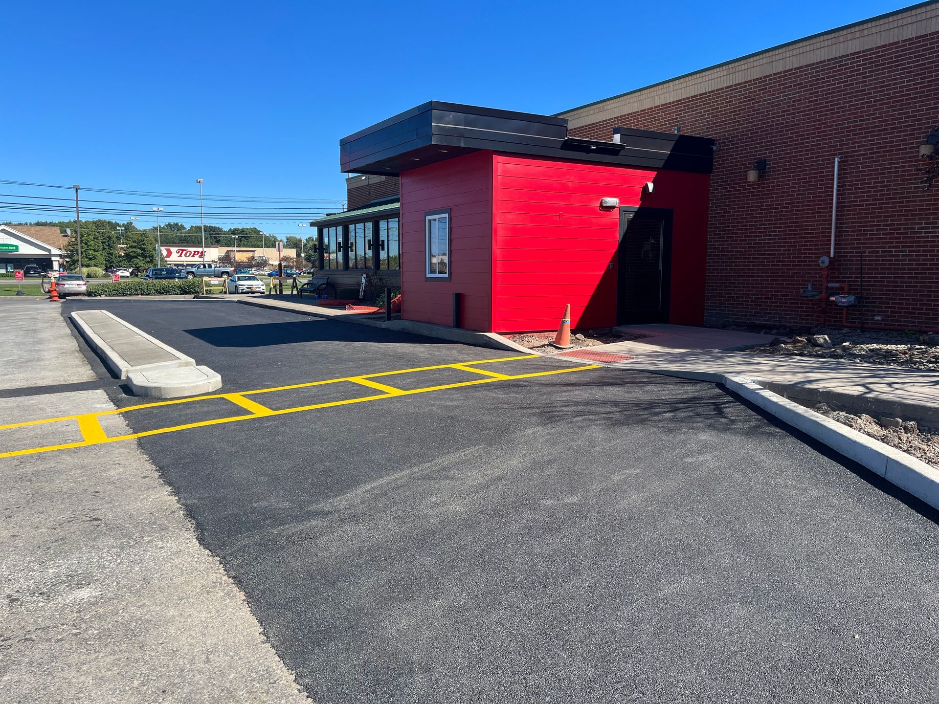 Commercial paving for a parking lot completed by Universal Paving & Concrete in Rochester, NY, designed to handle heavy traffic and wear.