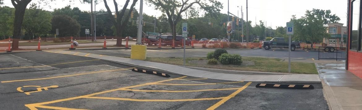 ADA-compliant commercial paving with smooth, sloped ramps by Universal Paving & Concrete in Rochester, NY, providing full access to business entrances.