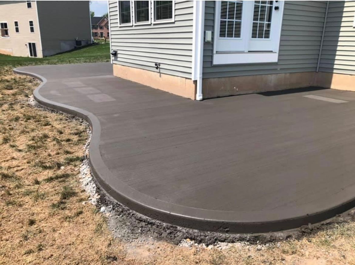 Brushed concrete driveway installation by Universal Paving & Concrete in Rochester, NY, offering a textured, non-slip surface for residential use.