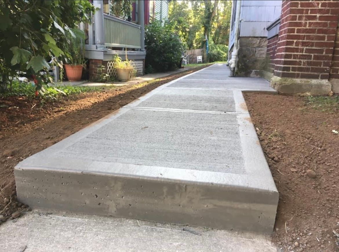 Brushed concrete sidewalk by Universal Paving & Concrete in Rochester, NY, providing a clean, textured finish that enhances both functionality and curb appeal