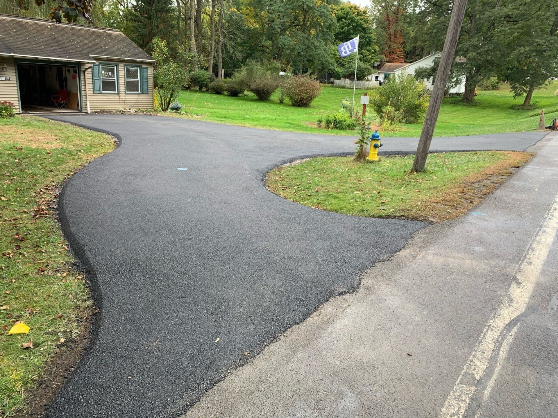 Universal Paving & Concrete asphalt driveway installation in Rochester, NY, with a focus on smoothness, durability, and efficient installation.