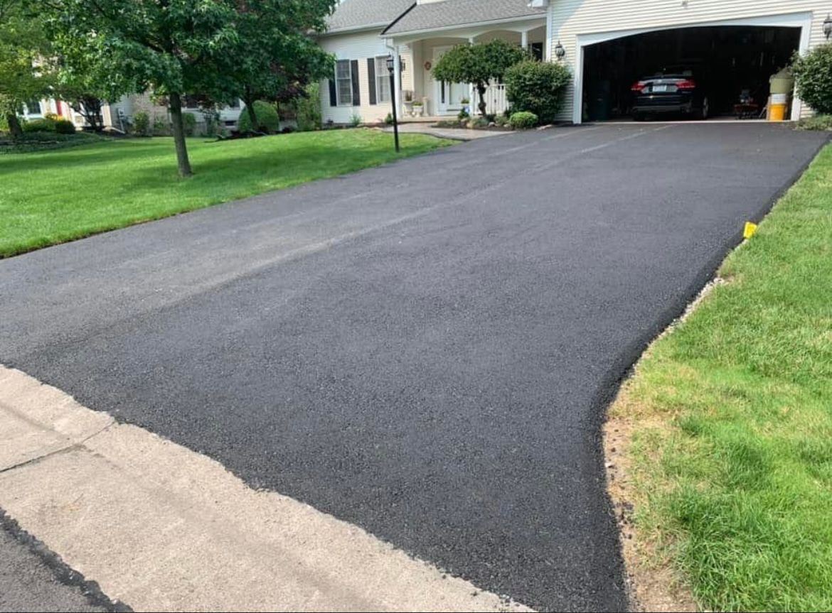 Newly paved asphalt driveway by Universal Paving & Concrete in Rochester, NY, offering a smooth and durable surface for residential properties.