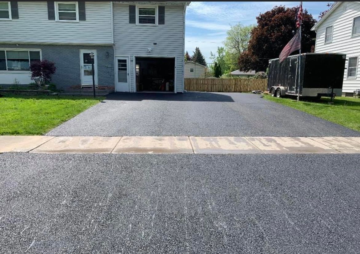 Smooth and freshly paved asphalt driveway in Rochester, NY, offering a clean, professional look for residential properties, installed by Universal Paving & Concrete.