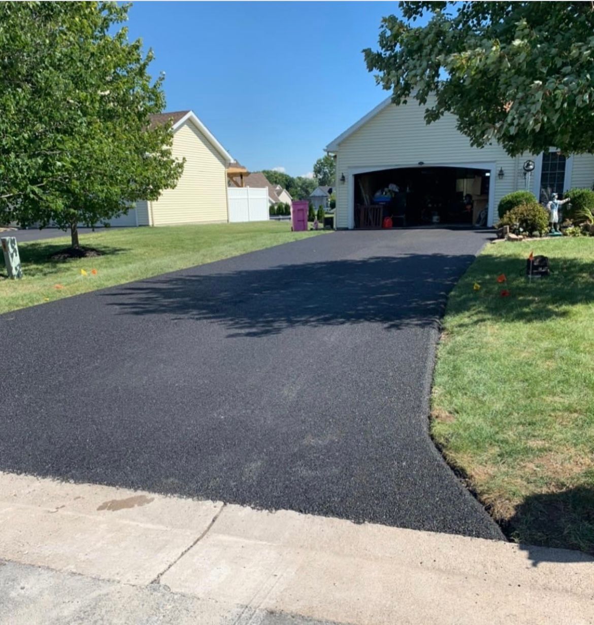 Newly installed asphalt driveway by Universal Paving & Concrete in Rochester, NY, showcasing a smooth and durable surface for residential use.
