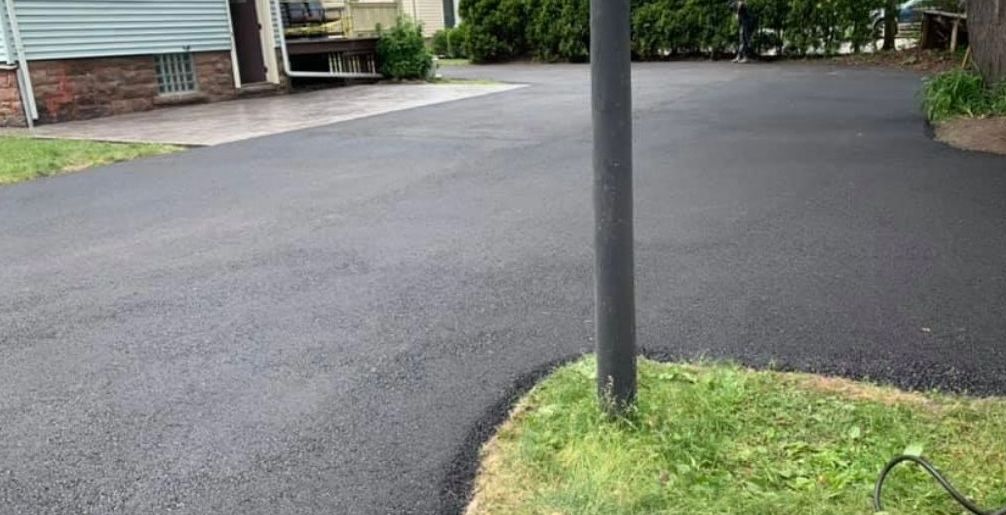 Rochester, NY asphalt driveway with proper drainage and smooth surface, expertly installed by Universal Paving & Concrete for optimal performance.