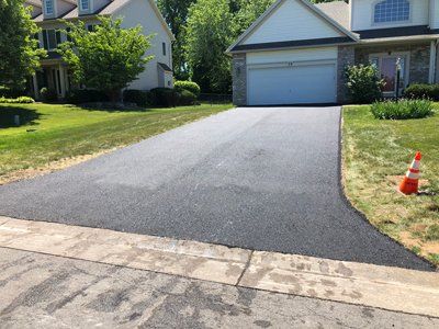 Asphalt driveway resurfacing by Universal Paving & Concrete in Rochester, NY, improving curb appeal and extending driveway life