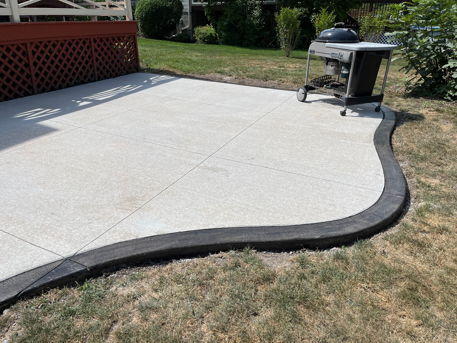 Stamped concrete patio installed by Universal Paving & Concrete in Rochester, NY, featuring a custom design with intricate textures and vibrant color.