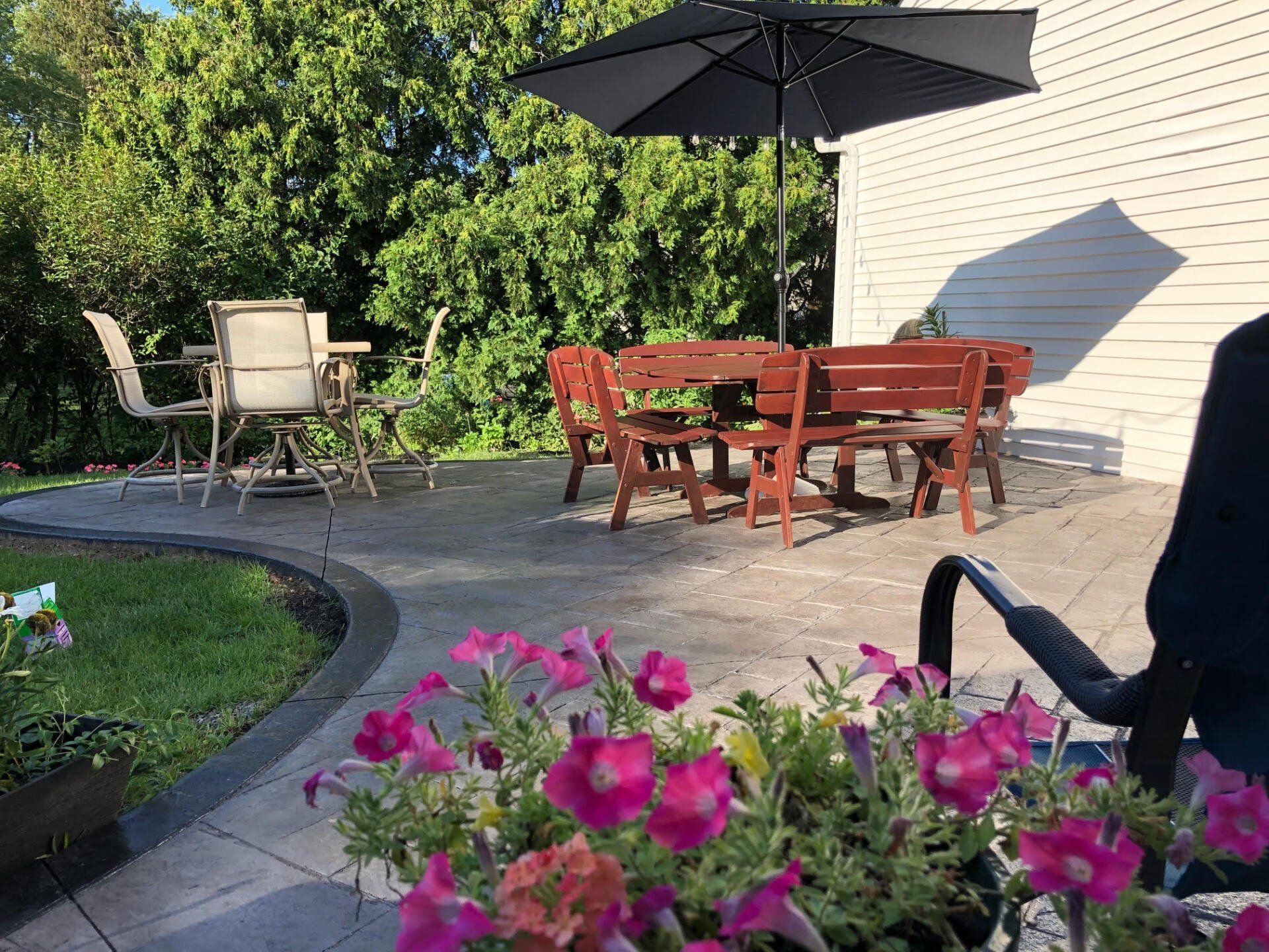 Close-up of a stamped concrete patio with a rustic cobblestone pattern, installed by Universal Paving & Concrete in Rochester, NY, perfect for outdoor gatherings.