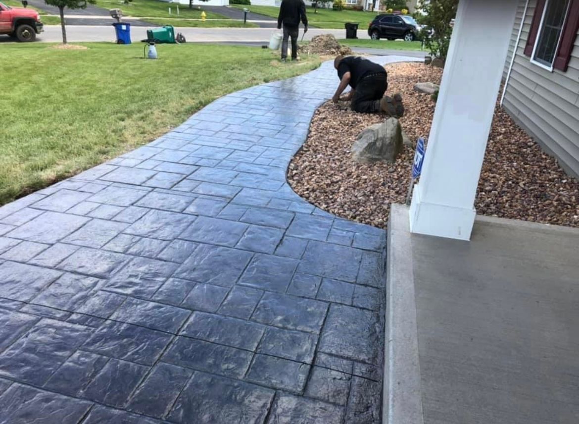 Expertly crafted stamped concrete sidewalk in Rochester, NY by Universal Paving & Concrete, blending aesthetics with functionality.