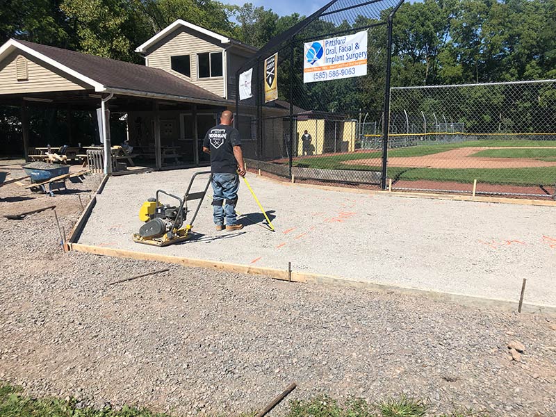 Universal Paving & Concrete installing a brushed concrete patio in Rochester, NY, providing a stylish, durable, and slip-resistant outdoor surface.