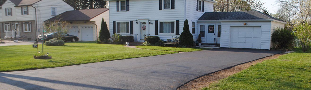 Close-up of freshly paved asphalt driveway with a smooth, even surface installed by Universal Paving & Concrete in Rochester, NY.