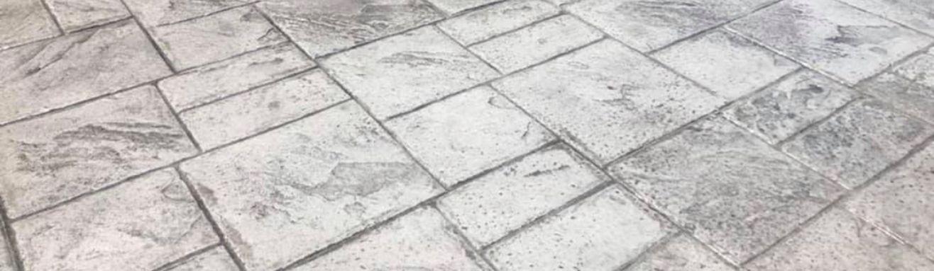 A close up of a stamped concrete floor with a pattern of squares. Rochester, NY