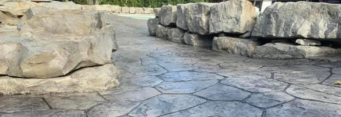Beautiful stamped concrete patio in Rochester, NY by Universal Paving & Concrete, enhancing outdoor living spaces with a durable and stylish surface