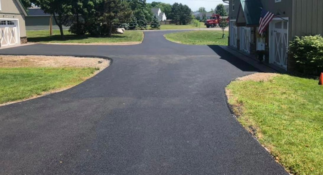 Driveway paving project by Universal Paving and Concrete in Rochester, NY, showcasing durable asphalt and expert craftsmanship for a smooth, long-lasting finish.