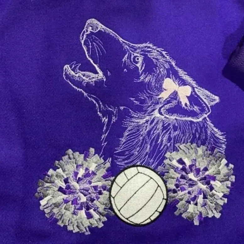 A purple shirt with a wolf volleyball and pom poms on it