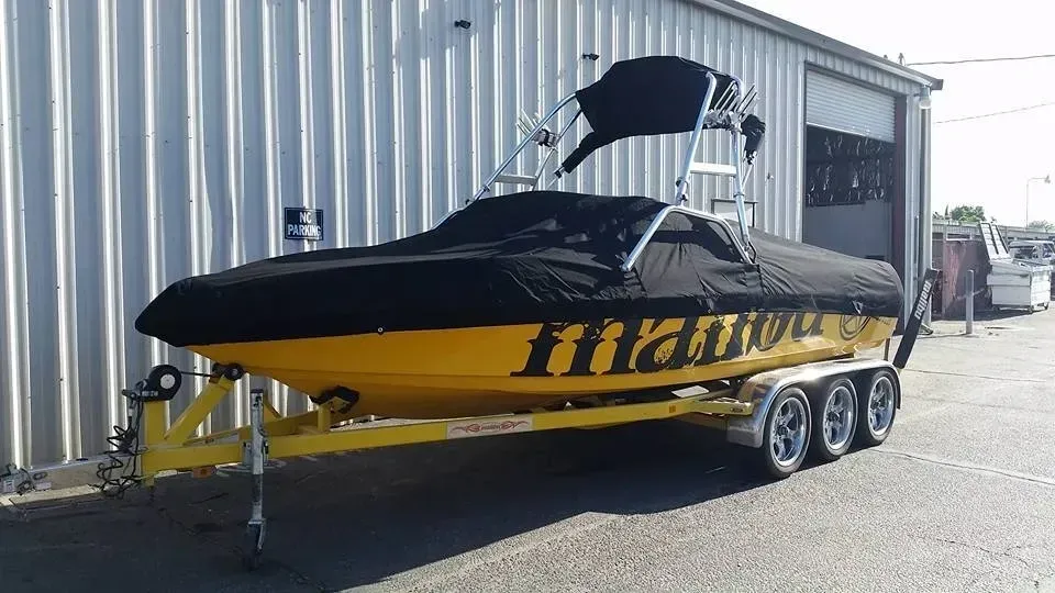 A yellow and black boat is parked in front of a building