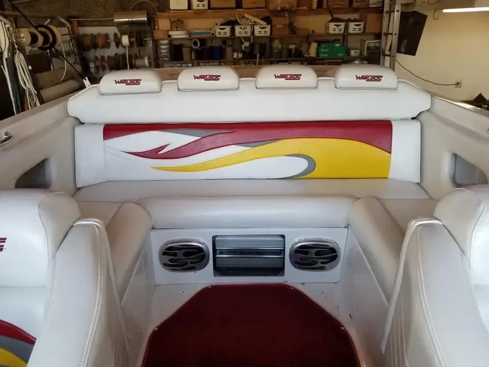 The back of a boat with a red yellow and white design