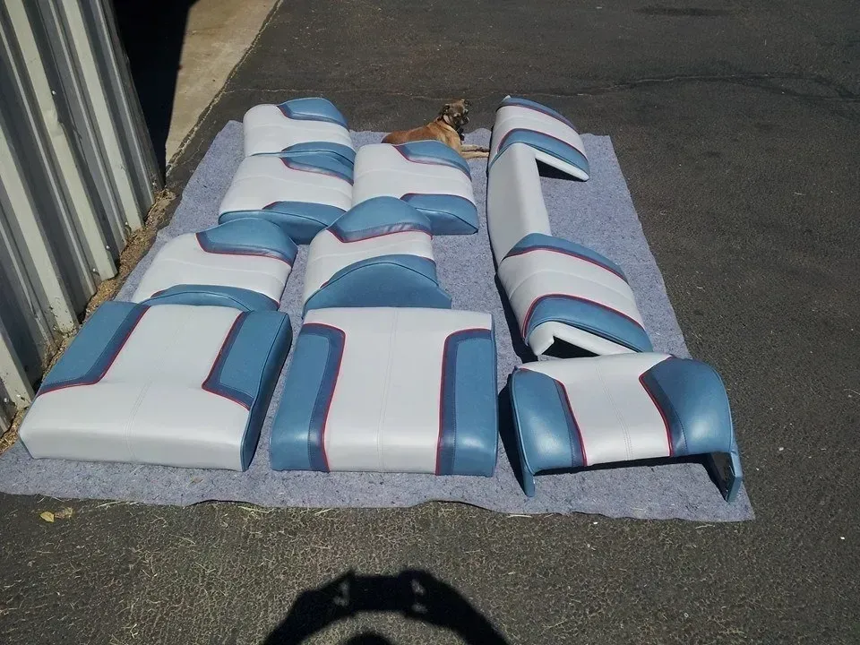 A bunch of blue and white seats are laying on the ground