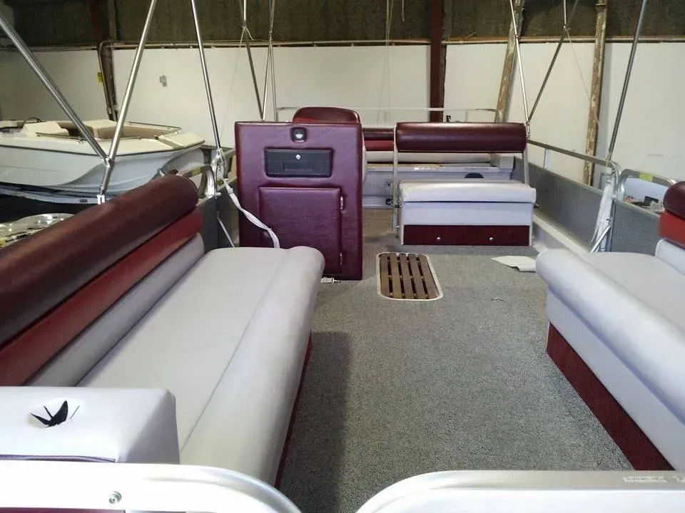 The inside of a boat with red and white seats