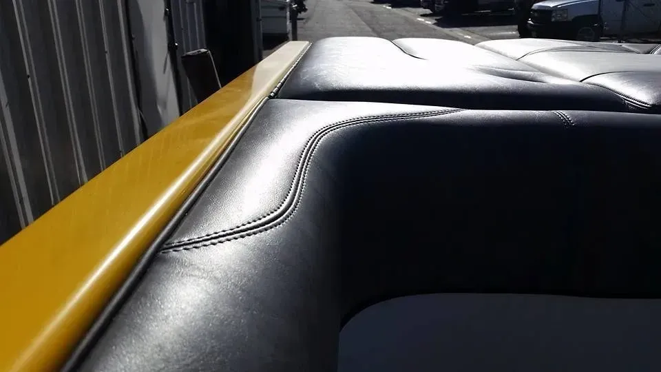 A black and yellow boat is parked in front of a building