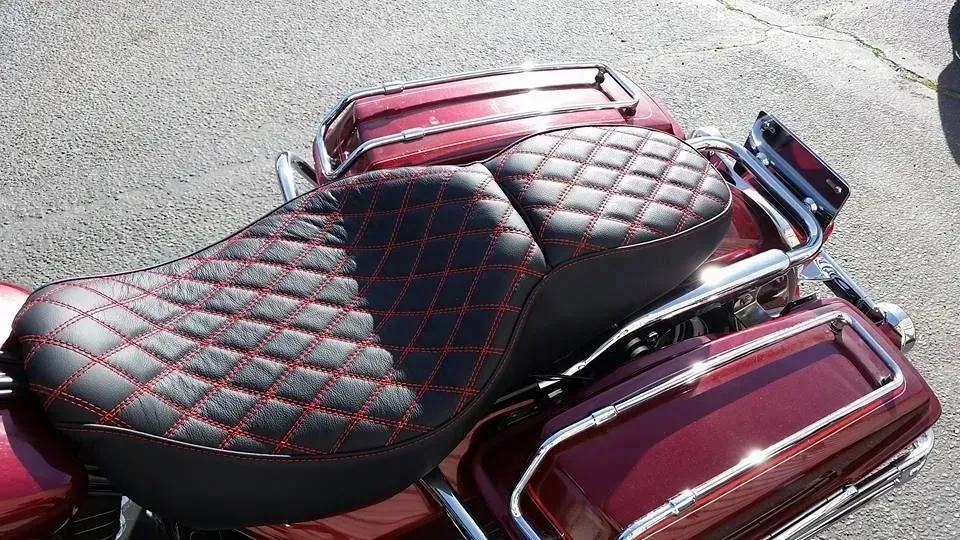 A red harley davidson motorcycle with a black and red seat