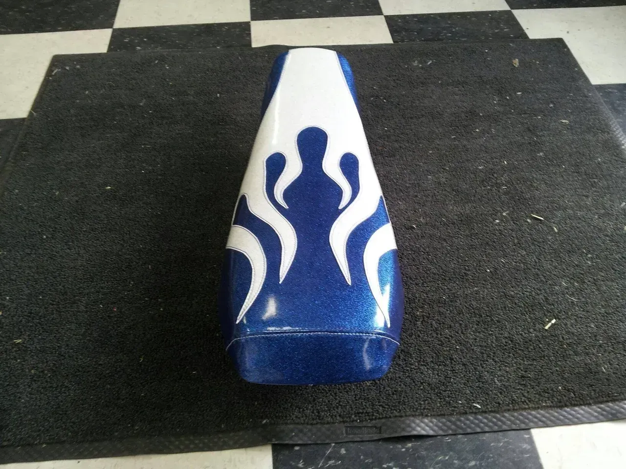 A blue and white vase with flames painted on it