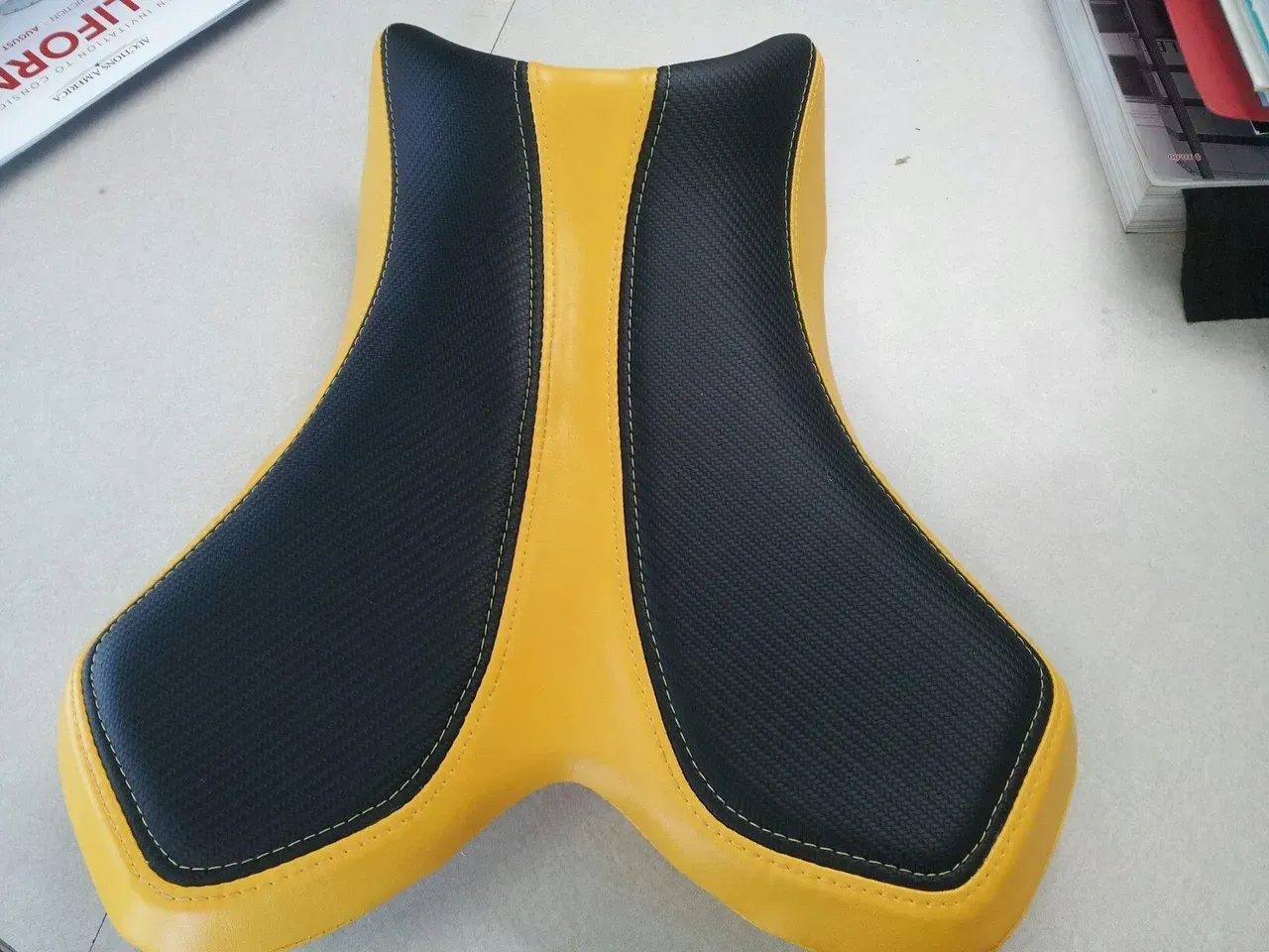 A yellow and black seat is sitting on a table